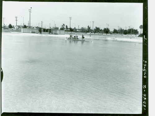 View of pool and pool cleaning boat in action at Alondra Park