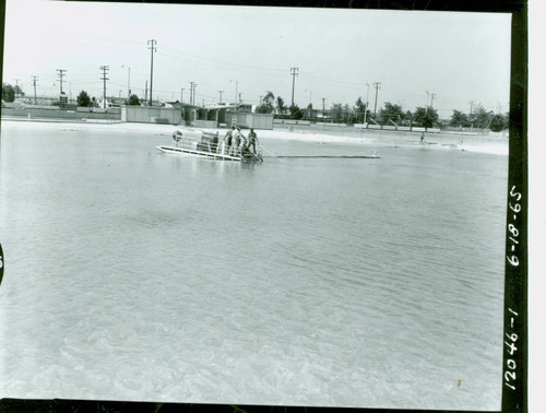 View of pool and pool cleaning boat in action at Alondra Park