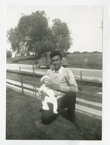 Eulogio Cabral holding Angel in their front yard, South Whittier, California