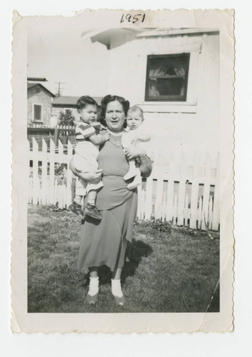 A mother with her two children in the backyard, Los Nietos, California