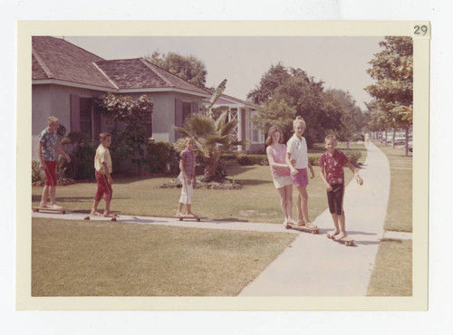 Kids skateboarding on Mines Boulevard, Los Nietos, California