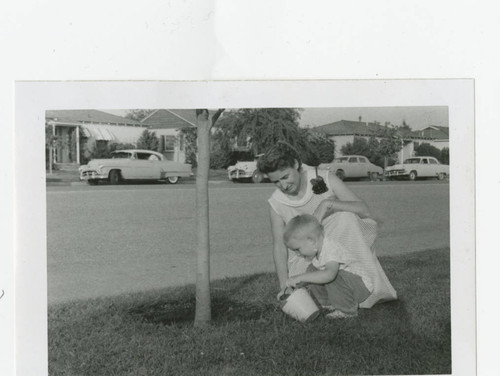 Jeffrey Poteet and Evelyn Poteet watering a tree, Los Nietos, California