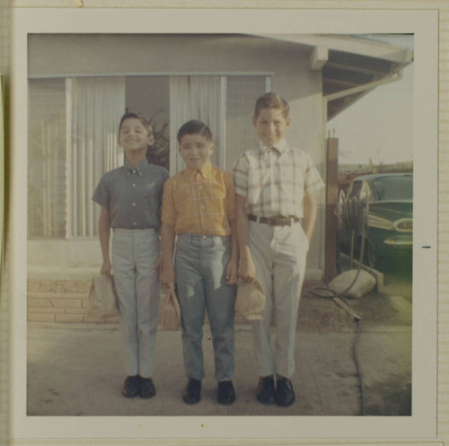 Holguin brothers and friend dressed for school