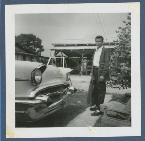 Angel Cabral standing by a car, Whittier, California