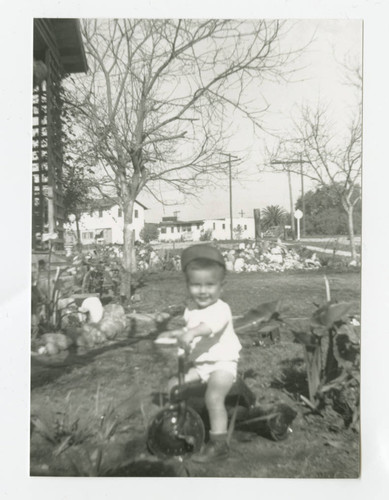 Angel Cabral on tricycle in front yard, South Whittier, California