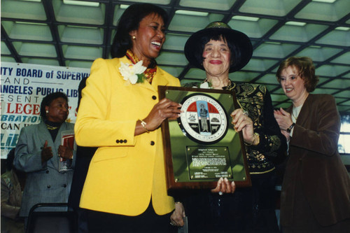 Yvonne Brathwaite Burke and Dorothy Donegan Hold Plaque