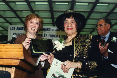 County Librarian and Dorothy Donegan Hold Plaque