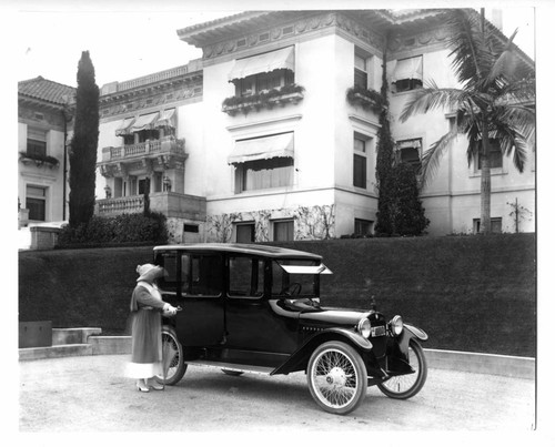 Mrs Merritt with automobile at H C Merritt residence