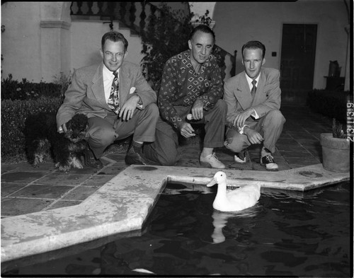 Men, dog and duck