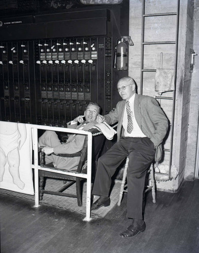 Men sit backstage