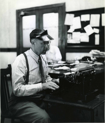 Harold in the newsroom of the Hollywood Citizen-News wearing his 'trademark' green visor, circa 1940