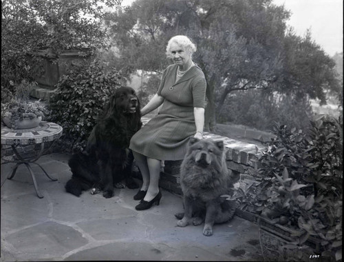 Mrs. Esther E. Hastings and her pet dogs