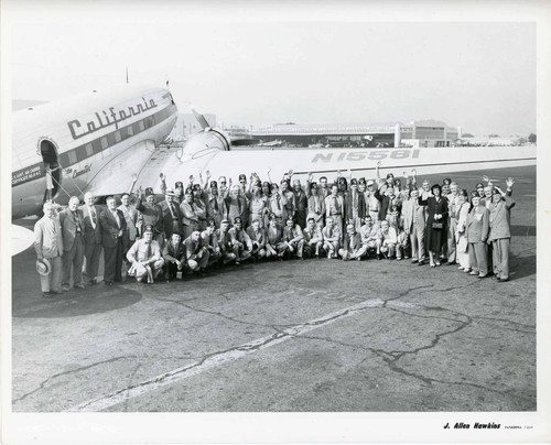 The Kora Temple convention attendees gathered in front of an airplane