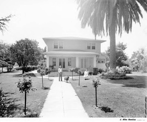 Couple with Dog near their House