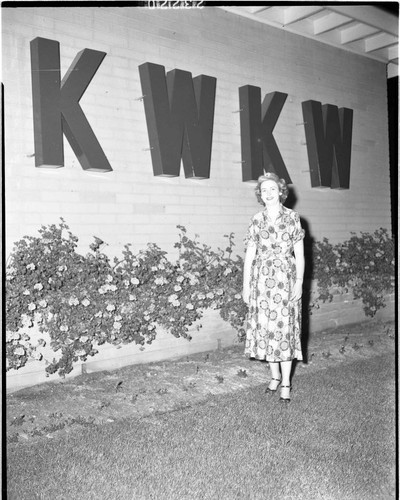 Woman standing in front of KWKW Radio Station