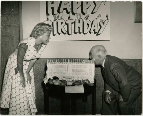 President Ray "Pop" Whitten of Woodbury College Takes a Bite out of His Birthday Cake