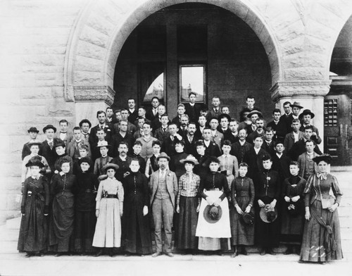 Woodbury College Students Stand in Front of the College Building