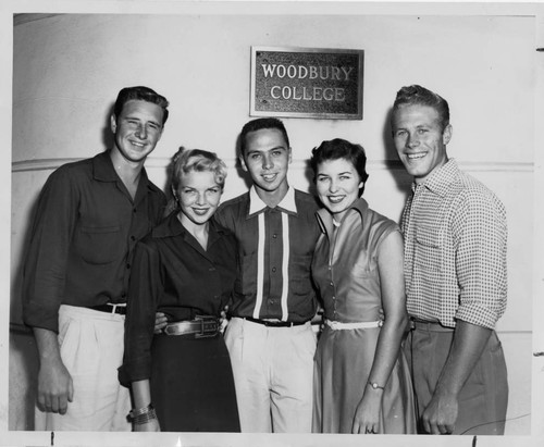 Standing under a Woodbury College Sign are Five Candidates for King and Queen of Smiles