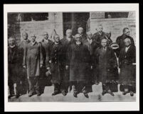 African American men standing in front of a brick church (?) building, undated