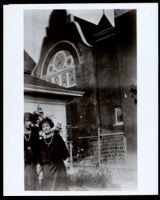 Two young African American women near a church, 1920s