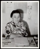 Charlotta Bass seated at her desk a the California Eagle, Los Angeles, 1930s