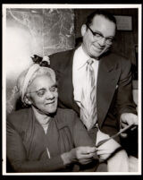 Dr. Vada Somerville and Bill Watkins look at a document, Los Angeles, 1950s