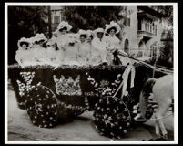 Ten young women in the horse-drawn Maryland Hotel float at the Tournament of Roses parade, Pasadena, 1908