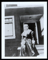 Woman in front of a house, 1860-1915