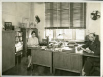 Cynthiabelle Gordon Smith and a male coworker in an office of the U.S. Public Health Service, Washington, D.C.,1939