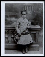 African American toddler next to a banister, 1870-1900