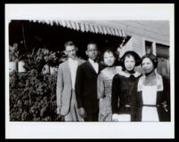 Miriam Matthews with four others in front of a house with an awning, 1910-1920