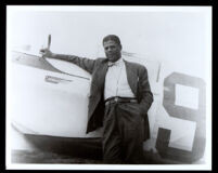 Hubert Julian with his Bellanca airplane, circa 1938-1939