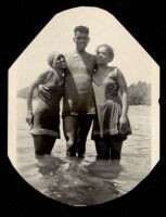 Young man and two women swimming, 1920s