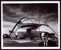 Paul R. Williams with the Theme Building at Los Angeles International Airport behind him, Los Angeles, circa 1961