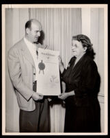 Gordon Hahn presenting a scroll to Pearl Hinds Roberts honoring her husband, Frederick Roberts, Los Angeles, circa 1957