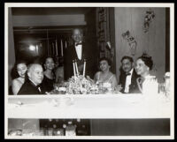 Dr. John Somerville with others having dinner at a hotel, 1940s-1950s