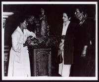 Beulah Woodard standing beside her work "Biddy Mason" facing two unidentified women, circa 1949