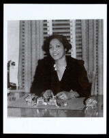 Bessie Bruington Burke seated at a desk, 1930-1945