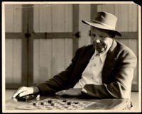 Titus Alexander playing checkers, between 1940-1952