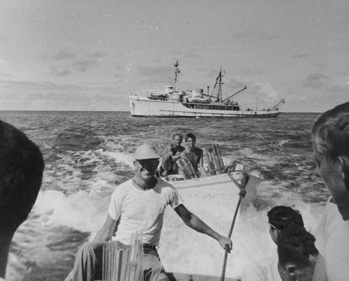 September 24, Bringing supplies ashore to set up camp "Little Petunia", Bikini Atoll. Left to right (foreground) Russell Raitt, Dick Morita, Roger Revelle, Tom Chapman (background) Deane Carlson, Edward Barr