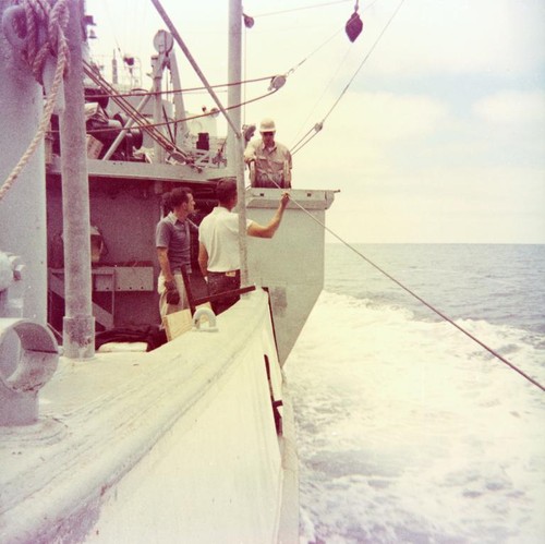 Wayne Runyon, Frank Hetzel, and James Snodgrass stream the G.E.K. (geomagnetic-electrokinetigraph) cable from the side bucket at 10 knots!