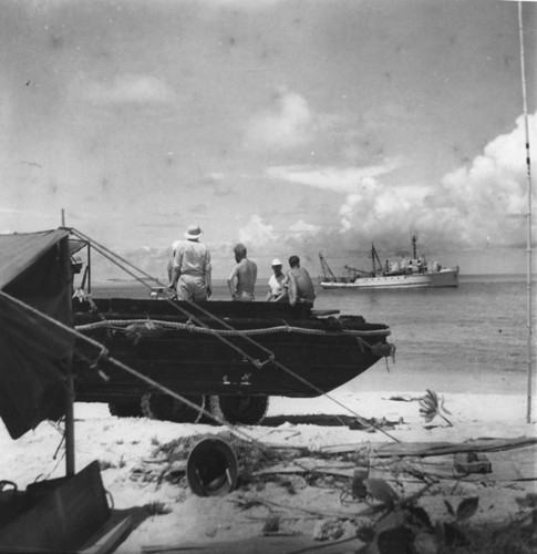 On Cheerete with R/V Horizon in background, wave recording cable is laid from the DUKW landing craft. Capricorn Expedition, October 23, 1952