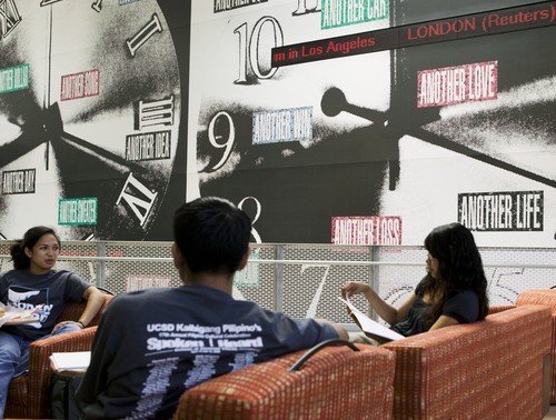 Another: view of students seated on upper platform in front of "clocks"