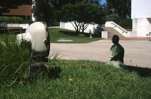 Something Pacific: detail: bronze buddha contemplating old television set