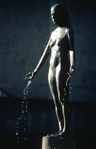Standing: detail view of bronze figure dripping water, with tiny representations of starfish configured on the torso as the constellation Virgo