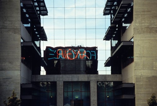 Vices and Virtues: neon reflected in adjacent building windows