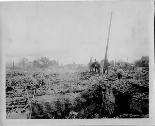 Men atop remains of a brick foundation