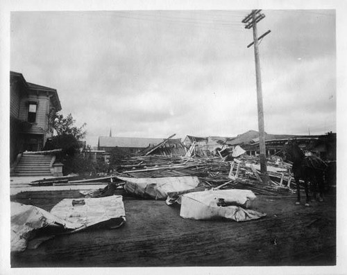 Flattened building next to damaged house