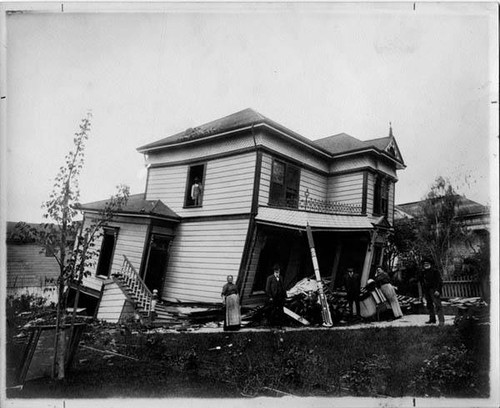 Family in front of earthquake-damaged Santa Rosa home