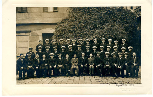 Formal group portrait in courtyard of customs building